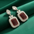 Tessara Gold-Plated Kundan Drop Earrings with Carved Maroon Stone