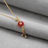 Tessara Gold-Plated Ruby-Toned Floral Dangler Pendant