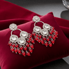 Tessara Silver-Plated Kundan Chandelier Earrings with Red Beaded Tassels