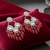 Tessara Silver-Plated Kundan Chandelier Earrings with Red Beaded Tassels
