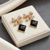 Tessara Gold-Plated Bow Drop Earrings with Black Square Stone