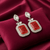 Tessara Silver-Plated Kundan Drop Earrings with Carved Coral Red Stone
